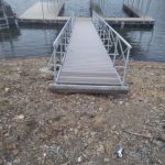 Covered double slip boat dock with aluminum walkway and handrails on Grand Lake in Oklahoma