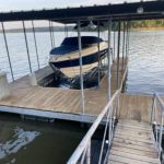 Covered boat dock slip with boat lift and wooden decking on Grand Lake, Oklahoma