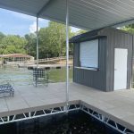 Covered boat dock with dock house, tiled deck, and seating area on Grand Lake in Oklahoma
