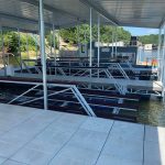 Covered multi slip boat dock with boat lifts at Grand Lake in Oklahoma, showing a durable custom lakefront dock installation