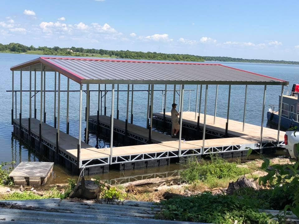 Covered multi slip boat dock on Grand Lake in Oklahoma with metal roof, open slips, and lakefront water access