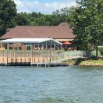 Custom covered boat dock with an aluminum gangway at a Grand Lake Oklahoma waterfront property