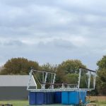 Custom dock structure under construction at an outdoor yard in Grand Lake Oklahoma, showing metal framing and floating dock modules