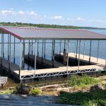 Covered multi slip boat dock on Grand Lake in Grand Lake Oklahoma with a metal roof and open slips over the water