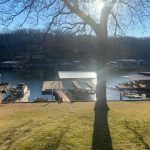 Lakefront dock area with multiple covered boat slips and boat lift installations on Grand Lake in Grand Lake Oklahoma