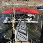 Covered boat dock with red canopy and lift on Grand Lake in Grand Lake Oklahoma